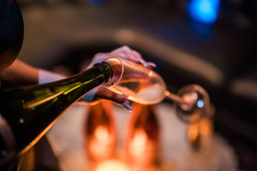 Guests celebrating in a luxurious VIP lounge with bottle service at an upscale gentlemen's club in West Palm Beach.